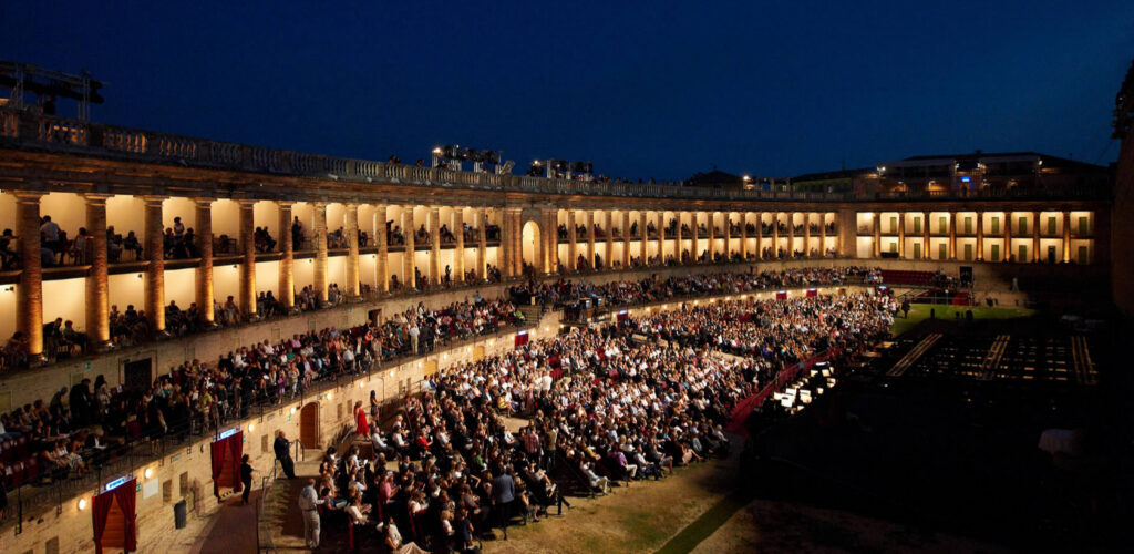 persone che assisstono ad un evento nel Sferisterio di Macerata